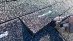 inspecting hail damage on home roof