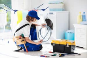 technician repairing a washing machine
